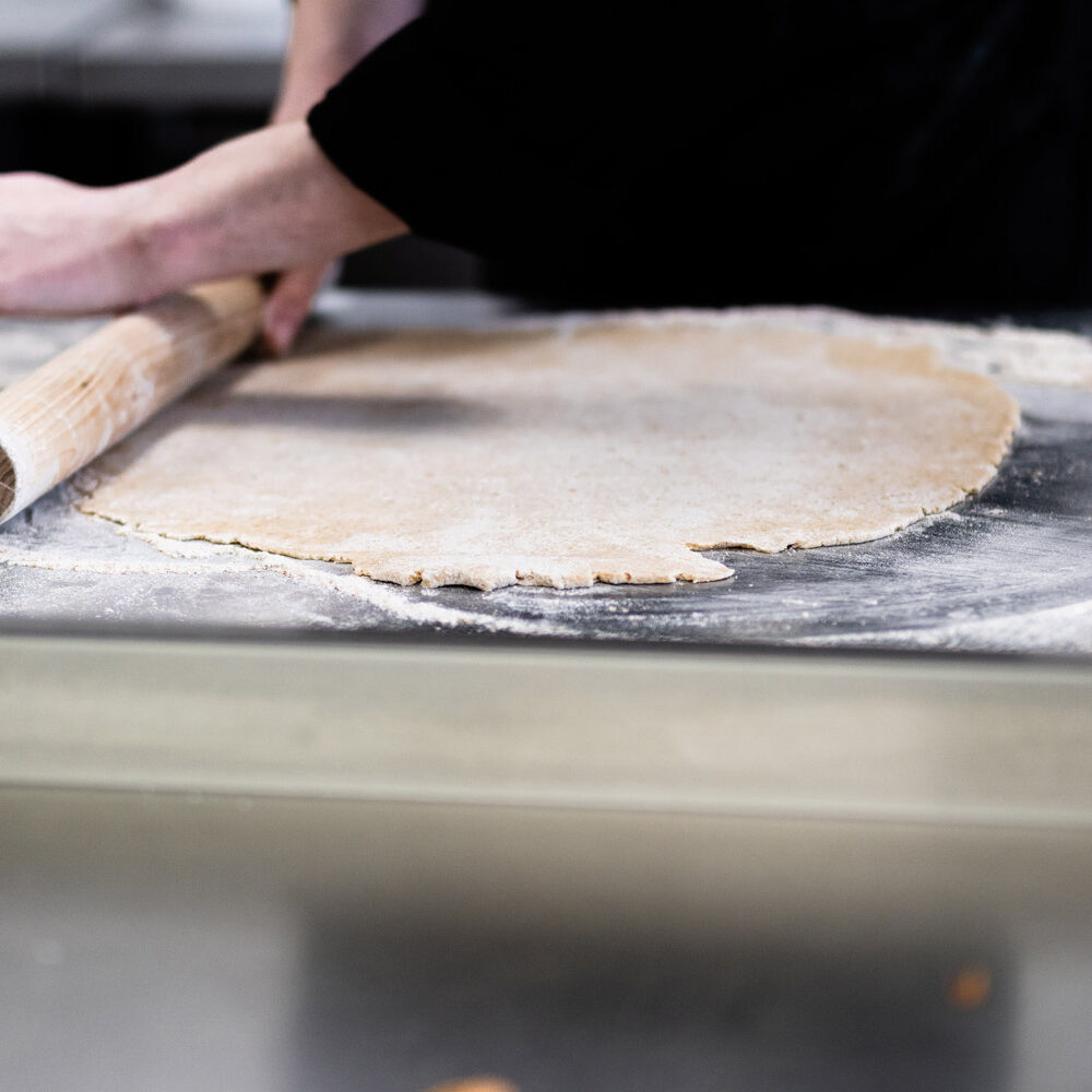 Hand rolling quiche base in the Basil kitchen